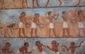 An Egyptian fresco from the Louvre museum showing workers harvesting ripe wheat