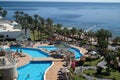 Egyptian garden with palm trees in the hotel. Swimming pool and accommodation in a tropical resort. Buildings, swimming pools and Royalty Free Stock Photo