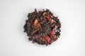 Egyptian hibiscus dry red tea (karkade) on a transparent round plate Royalty Free Stock Photo