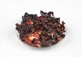 Egyptian hibiscus dry red tea (karkade) on a transparent round plate Royalty Free Stock Photo