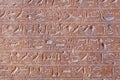 Egyptian hieroglyphs on the ancient pyramid wall.