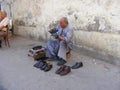 Shoeblack man cleaning shoes