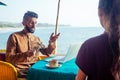 Egyptian man foreign language teacher teaching female student at tropical cafe Royalty Free Stock Photo