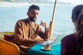 Egyptian man foreign language teacher teaching female student at tropical cafe Royalty Free Stock Photo