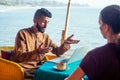 Egyptian man foreign language teacher teaching female student at tropical cafe Royalty Free Stock Photo