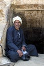 An Egyptian man sits at the entrance to a tunnel inside the Red Pyramid in Egypt.