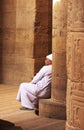 Egyptian man sitting by the column, Philae Temple Royalty Free Stock Photo