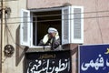 An Egyptian man surveys the steets below his apartment in Edfu in Egypt.