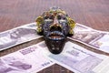 Egyptian mask lies at Egyptian pounds. Royalty Free Stock Photo