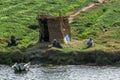 Egyptian men relax on the bank of the River Nile in the late afternoon near Esna Lock in Egypt.
