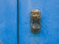 Egyptian metal door knocker on an old blue door Royalty Free Stock Photo