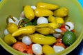 Egyptian pickles inside a deep plastic bowl, marinated preserved pickled vegetables of chili peppers, onions, lemon and safflower