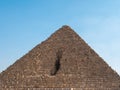 Egyptian pyramid made of stone blocks against the blue sky. Close-up Royalty Free Stock Photo