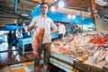 Egyptian seller showing big fresh fish