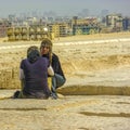 Egyptian Women Pyramid Vendors. Cairo in the background.