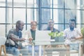 ehind the glass view of executives discussing project in modern office