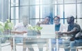 ehind the glass view of executives discussing project in modern office