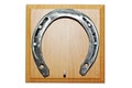 EHorseshoe on wooden base. Royalty Free Stock Photo
