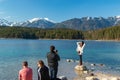 Eibsee, Germany, March 31, 2019: husband taking selfie of his wife for instagram at eibsee