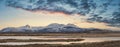 Eic landscape image of Snowdonia snowcapped mountains with dramatic sunset clouds and beautiful vibrant glow