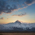 Eic landscape image of Snowdonia snowcapped mountains with dramatic sunset clouds and beautiful vibrant glow