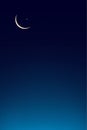 Eid al Adha Mubarak card,Crescent Moon on Blue Twilight Sky in Evening,Vertical Sunset after sundown,Dusk sky with copy space,