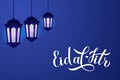 Eid al-Fitr calligraphy hand lettering with lanterns on blue Arabic pattern background. Muslim holiday typography poster. Islamic