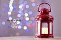 Eid al-Fitr Mubarak Greeting Typography with Bokeh backgound. Arabic lantern on wooden backgound Royalty Free Stock Photo