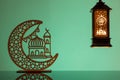 Eid Mubarak concepts with lamp inscribed with arabic text translated to english as Ramadhan is our light., with crescent