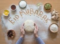 Eid Mubarak - Islamic holiday welcome phrase ` happy holiday`, greeting reserved. Arabic cuisine background.