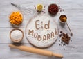 Eid Mubarak - Islamic holiday welcome phrase ` happy holiday`, greeting reserved. Arabic cuisine background.