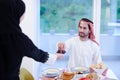 Muslim family having Iftar dinner eating dates to break feast Royalty Free Stock Photo