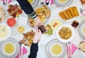 Muslim family having Iftar dinner eating dates to break feast top view Royalty Free Stock Photo