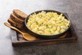 Eiersalat is a creamy German egg salad with cubes of crisp apple and crunchy sour pickles. closeup on the wooden board. Horizontal