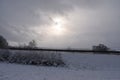 snowy Eifel road near Barweiler on a dark day