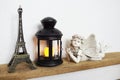 Eiffel statue, black lantern and fairy statue on wooden shelves Royalty Free Stock Photo