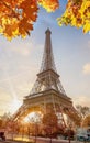 Eiffel Tower with autumn leaves against colorful sunset in Paris, France Royalty Free Stock Photo