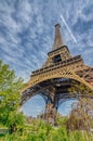 Strange view of the Eiffel tower with blue sky and a plane above, Paris. France Royalty Free Stock Photo
