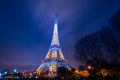 Eiffel Tower brightly illuminated at dusk