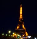 Eiffel Tower brightly illuminated at dusk in Paris