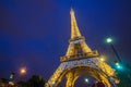 Eiffel Tower brightly illuminated at twilight, Paris