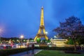 Eiffel Tower brightly illuminated at twilight