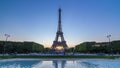 Eiffel Tower day to night timelapse and people sitting on the grass in the evening in Paris, France Royalty Free Stock Photo