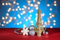 Eiffel Tower golden decor, toy. Christmas, New Year decorations, ornaments. Blue golden blurred bokeh background. Royalty Free Stock Photo