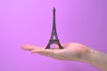 Eiffel tower handed by hand close up bronze souvenir