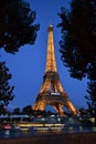 Eiffel Tower illuminated by night on blue sky. Royalty Free Stock Photo