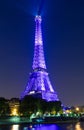 The Eiffel tower lit up in purple color at night, Paris, France Royalty Free Stock Photo