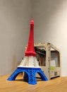 Eiffel Tower Model with Red White Blue Stripe printed by 3D Printer with 3D Printer on Wooden Table Royalty Free Stock Photo