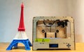 Eiffel Tower Model with Red White Blue Stripe printed by 3D Printer with 3D Printer on Wooden Table