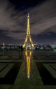 Eiffel Tower at night with reflection in rainwater